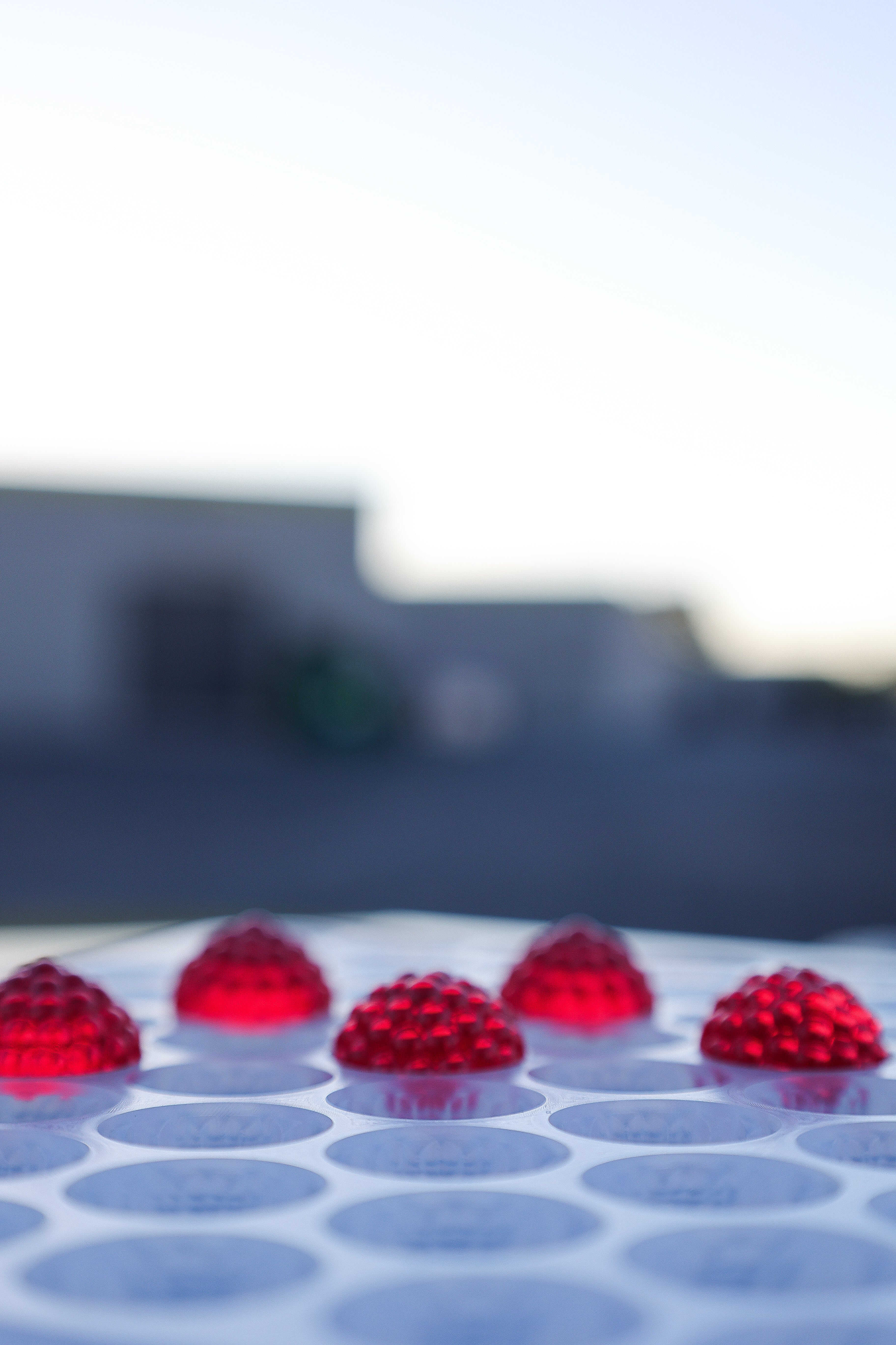 A group of red balls on a white surface.
