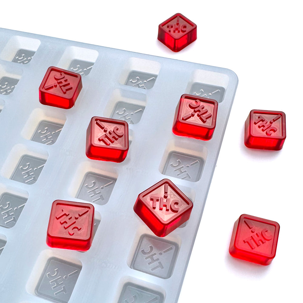 Food-grade custom silicone square gummy mold, 2.5ml cavities featuring CO, OH, NM & FL-compliant embossed logo, shown with red gummies, universal depositor compatible.