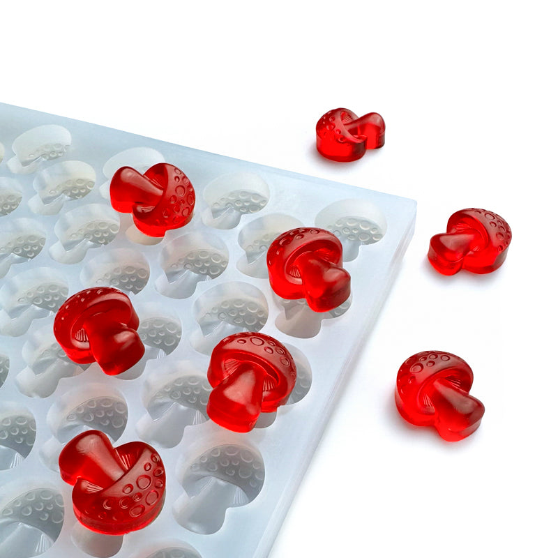 Custom food-grade silicone Mushroom mold, 3.2ml cavities with detailed mushroom design, shown with red gummies, perfect for fill and scape.