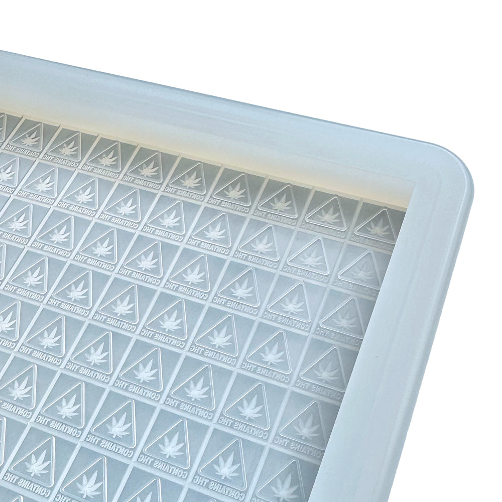 Custom food-grade silicone slab mold with 3ml square cavities featuring embossed state-compliant symbols for MA, ME, and RI, designed for high-volume gummy production.