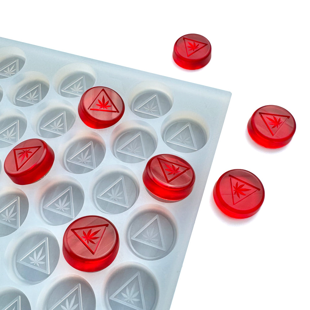 Custom food-grade silicone disc gummy mold, 3ml round cavities with NJ-compliant embossed symbol, shown with red gummies, compatible for hand pour & flood & scrape.