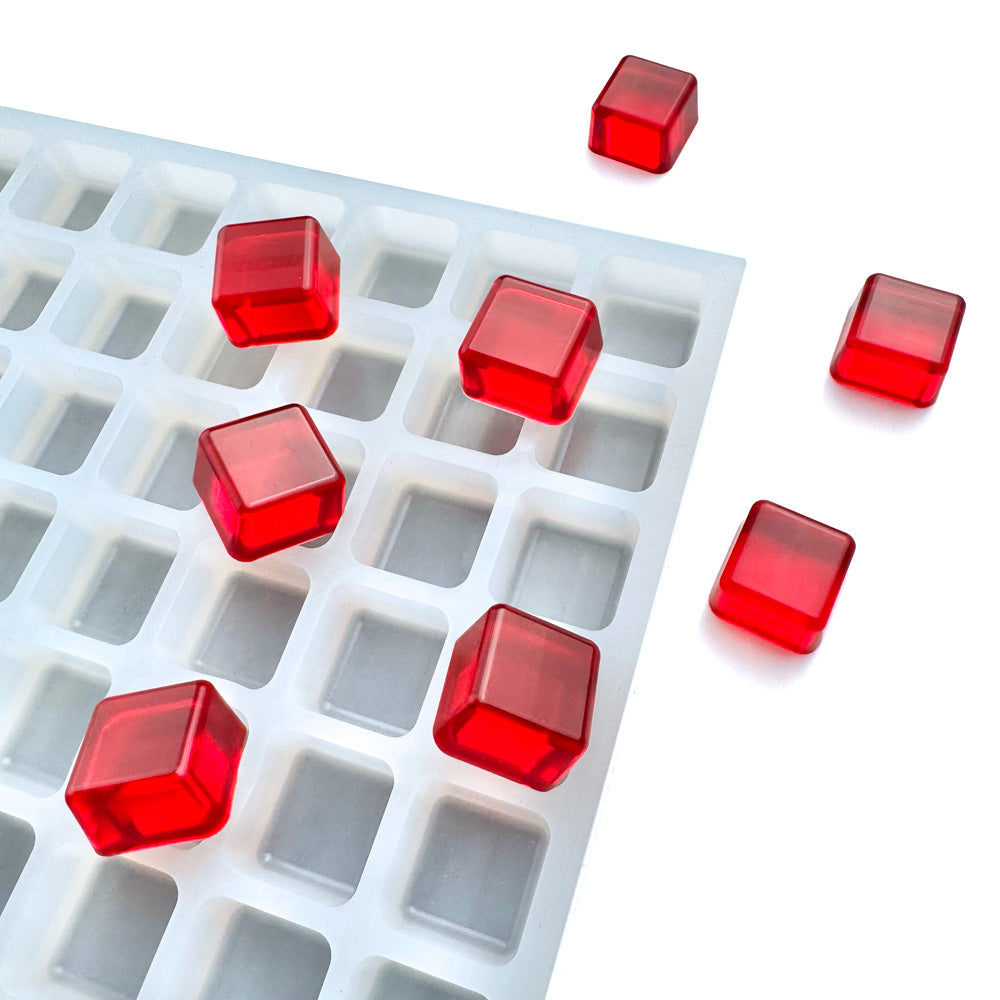Red gelatin cubes are displayed on and around the Vector Molds 3 mL Square Gummy Mold - Sharp Half Sheet (266 Cavities), a food-grade silicone mold with square compartments, set against a white background.