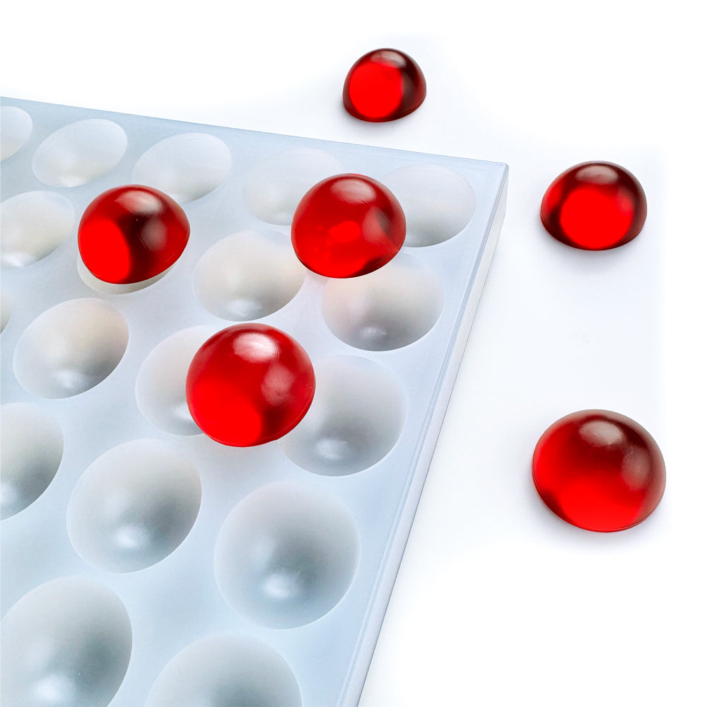 Custom food-grade silicone bon bon gummy mold, 6ml smooth round dome cavities, shown with red gummies, compatible with universal depositor machines.