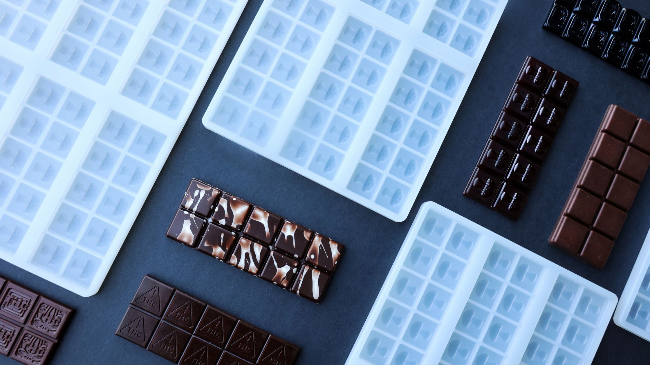 Commercial silicone molds for chocolate bars and gummies with precision cavities, designed for high-volume confectionery production