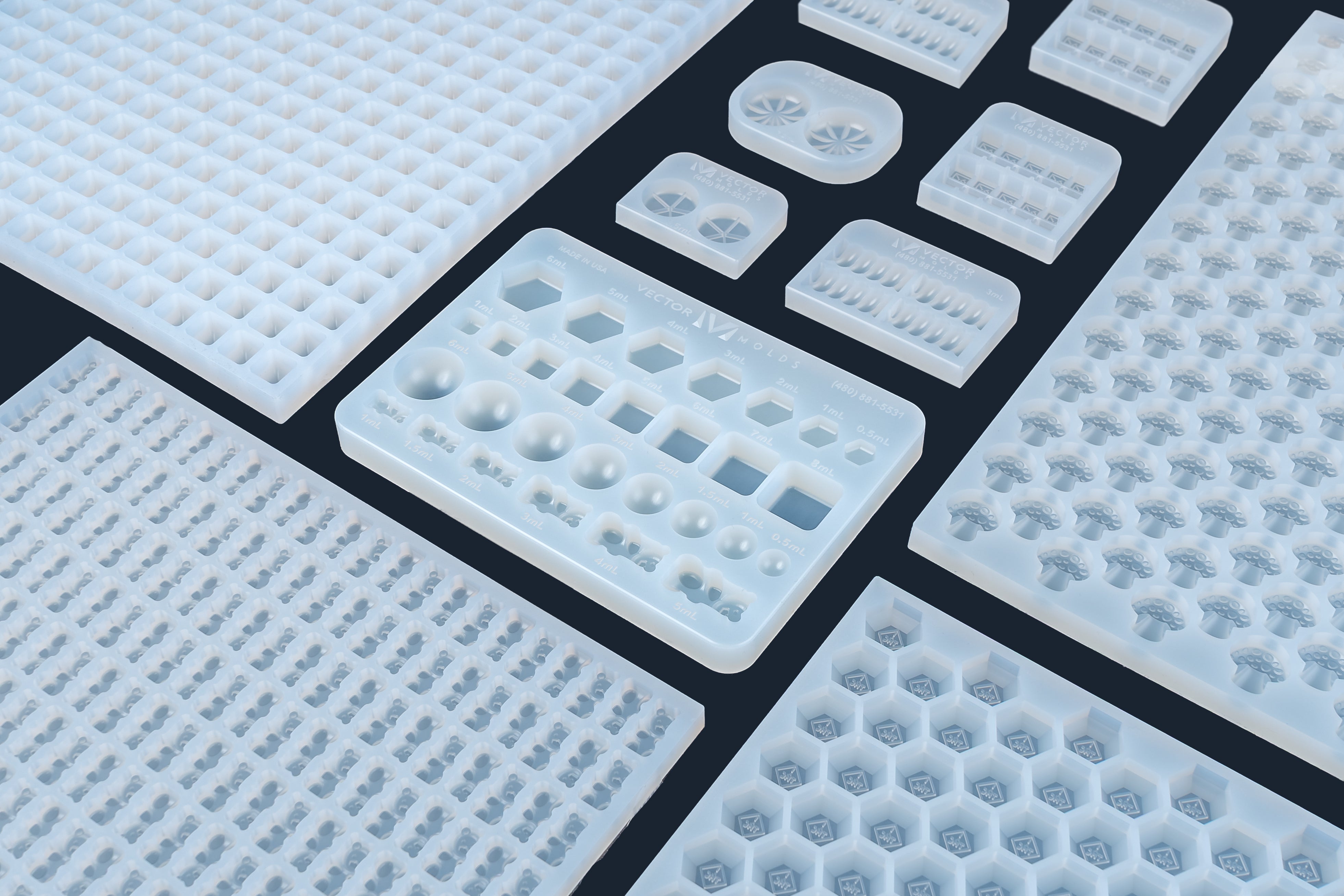 Vector Molds professional food-grade silicone gummy candy molds with various cavity shapes.