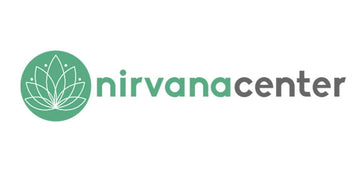 Logo with a green circle containing a white lotus flower graphic, next to the text "nirvana center" in green and gray letters.