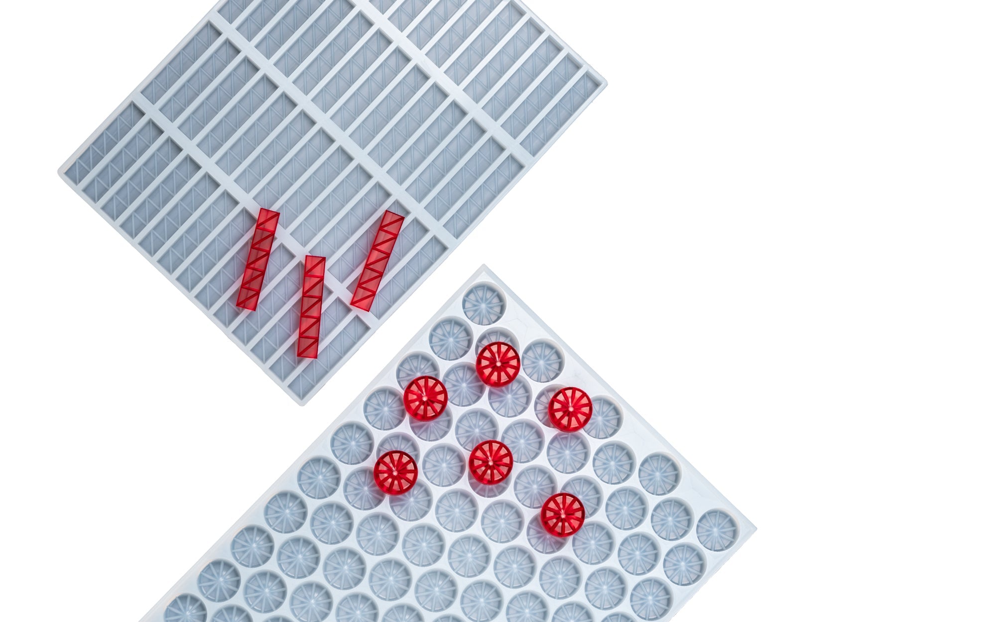 A close-up of a blue ice cube tray holding several red gelatin cubes arranged in clusters, with a dark gradient background.