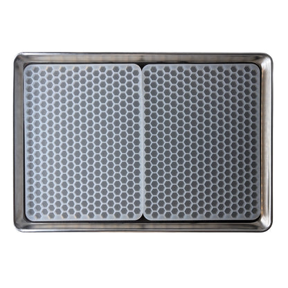 A Vector Molds 2 mL Hexagon Gummy Mold - Half Sheet with 331 cavities, featuring two food-grade silicone mats with a honeycomb pattern, fits side by side on a metal baking sheet.