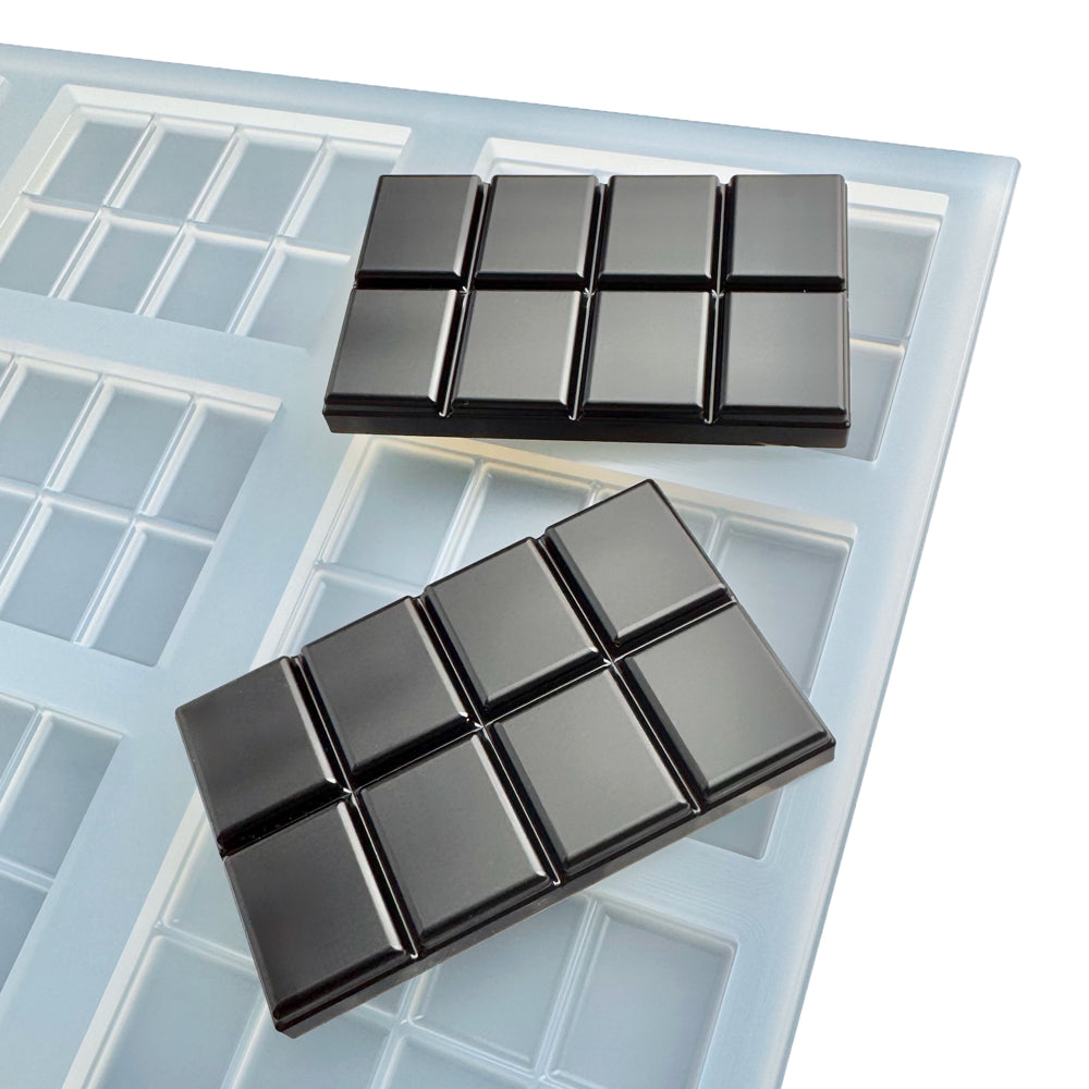Quarter sheet food-grade platinum silicone mold with 9 square chocolate bar cavities engineered for commercial confectionery and gummy production. Each cavity measures 50x80x8 mm with a 30 mL total volume and features 8 precision-scored breakable pieces at 3.75 mL each for consistent portion control and clean separation. High-polish silicone mold designed for chocolate, candy, supplement gummies, and nutraceutical applications with sharp cavity detail, easy release, and production-ready durability. Made in 