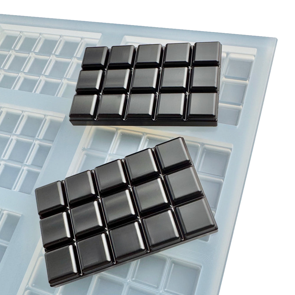 Food-grade platinum silicone quarter sheet mold featuring 9 square chocolate bar cavities with precision-scored breakable sections. Each cavity measures 50x80x8 mm with a 30 mL total volume and 15 evenly divided 2 mL breakable pieces for accurate portioning. Commercial-grade silicone mold designed for chocolate bars, gummies, candy, nutraceuticals, and confectionery production with easy demolding, sharp detail, and production-ready performance. Made in USA by Vector Molds