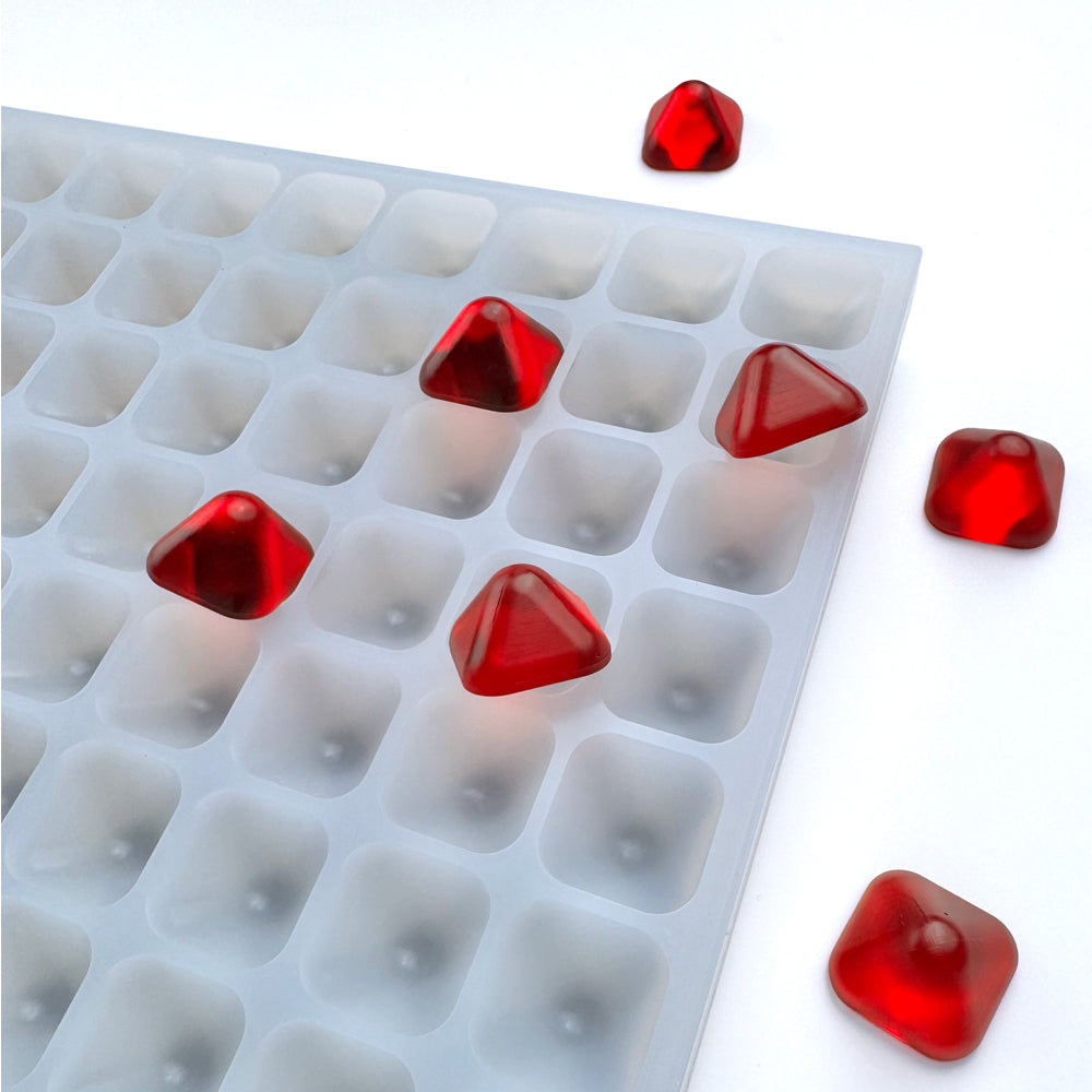 Custom food-grade silicone pyramid gummy mold, 3ml cavities designed for clean demolding, compatible with universal depositor machines, shown with red gummies.