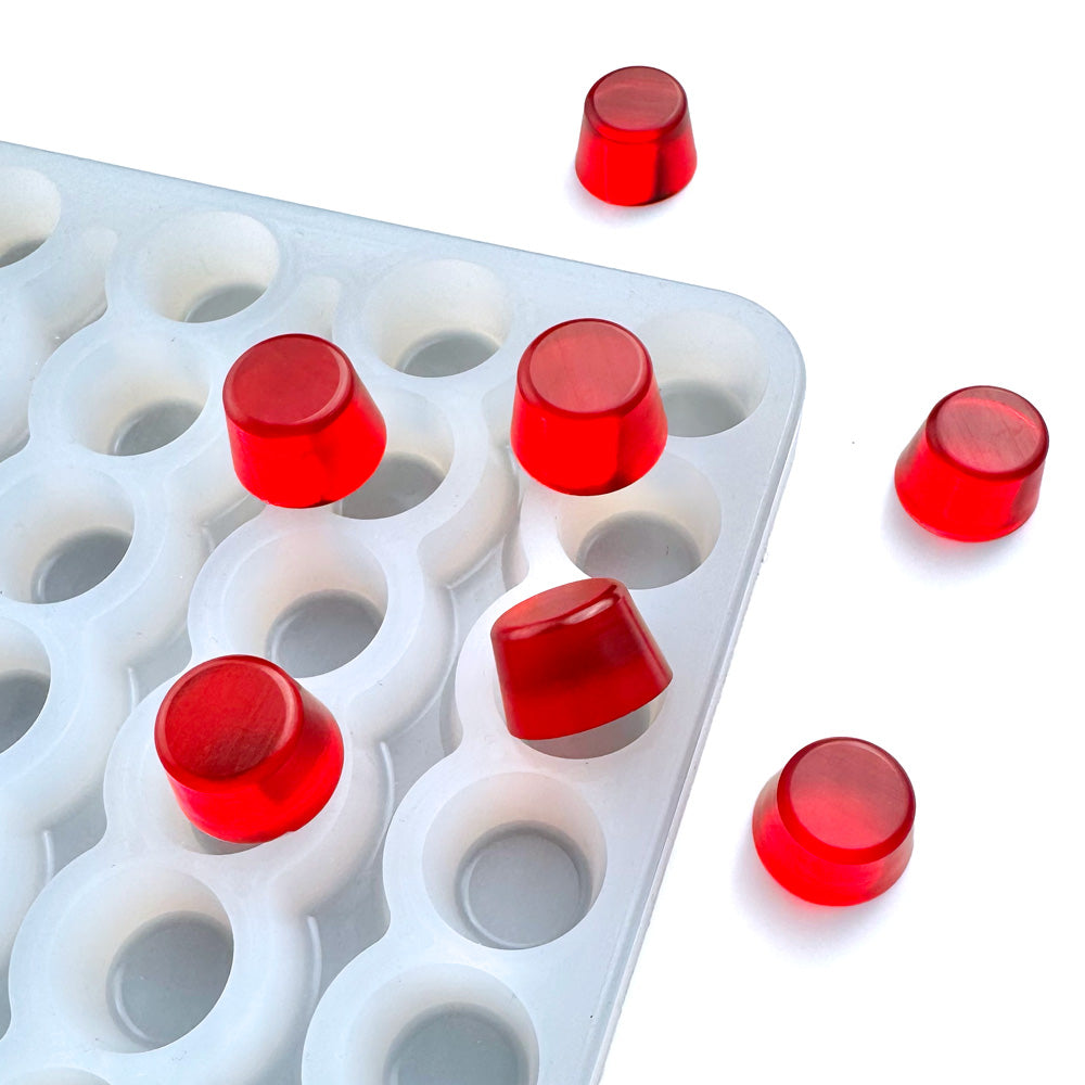 Food-grade silicone rolo cylinder gummy mold, 3ml round flat-top cavities with smooth tapered sides, shown with red gummies, universal depositor compatible.