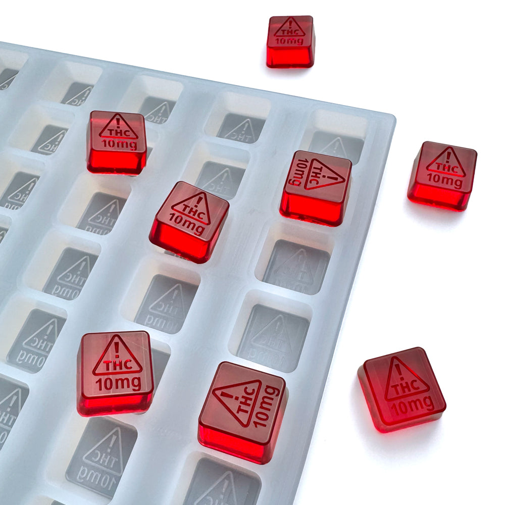 Food-grade custom silicone square gummy mold, 4ml cavities featuring NV and MS-compliant embossed logo 10mg, shown with red gummies, universal depositor compatible.