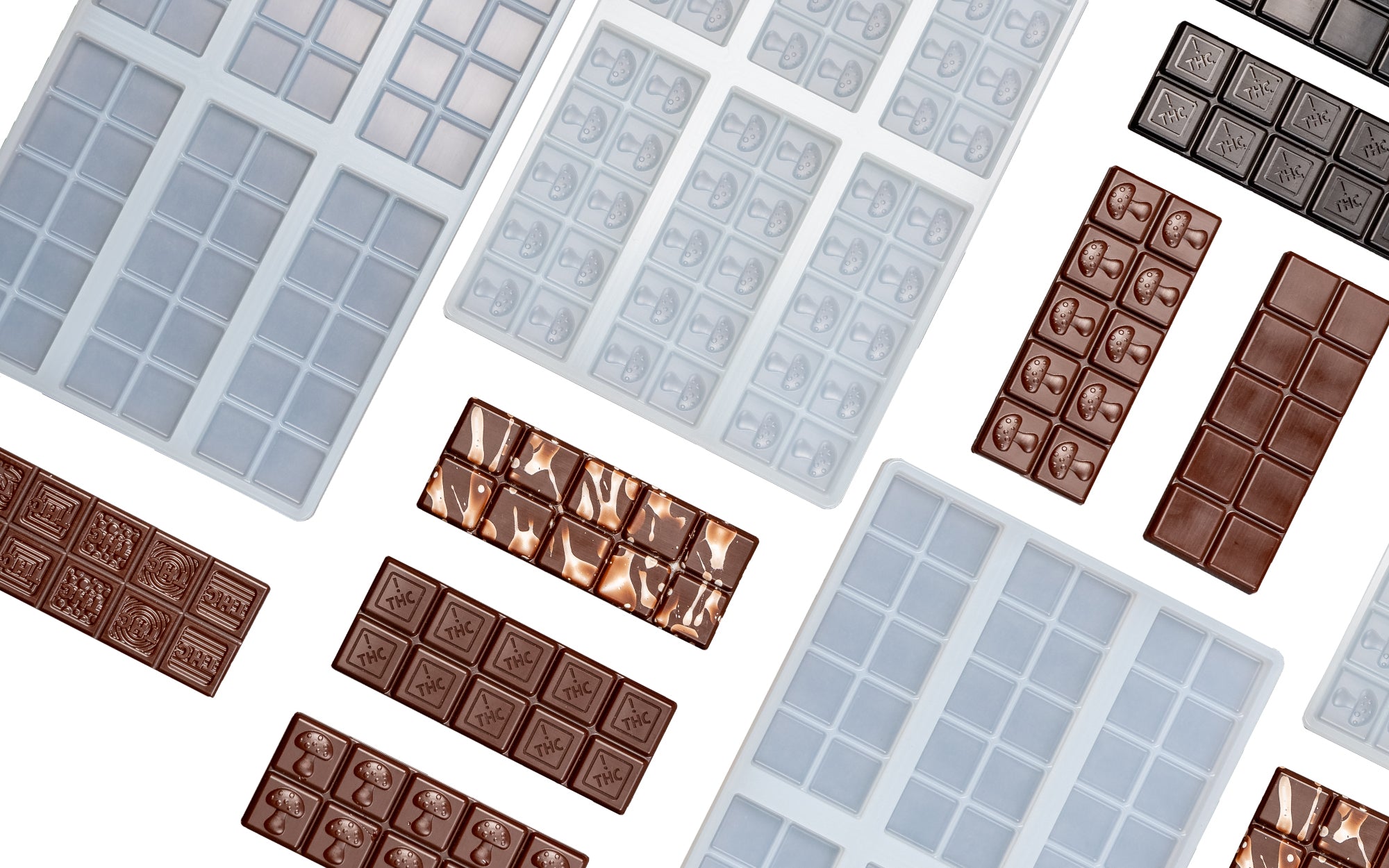 Assorted silicone chocolate bar molds and various finished chocolate bars arranged on a dark surface.