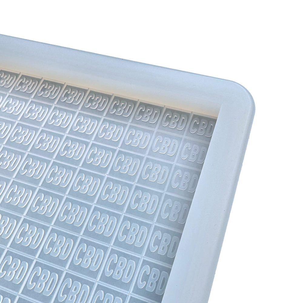 The Vector Molds 3 mL Square CBD Gummy Slab Mold features a half sheet with 1 large cavity that produces up to 450 rectangular candies embossed with "CBD." Made from professional food-grade silicone, it ensures safe and precise CBD gummy creations.
