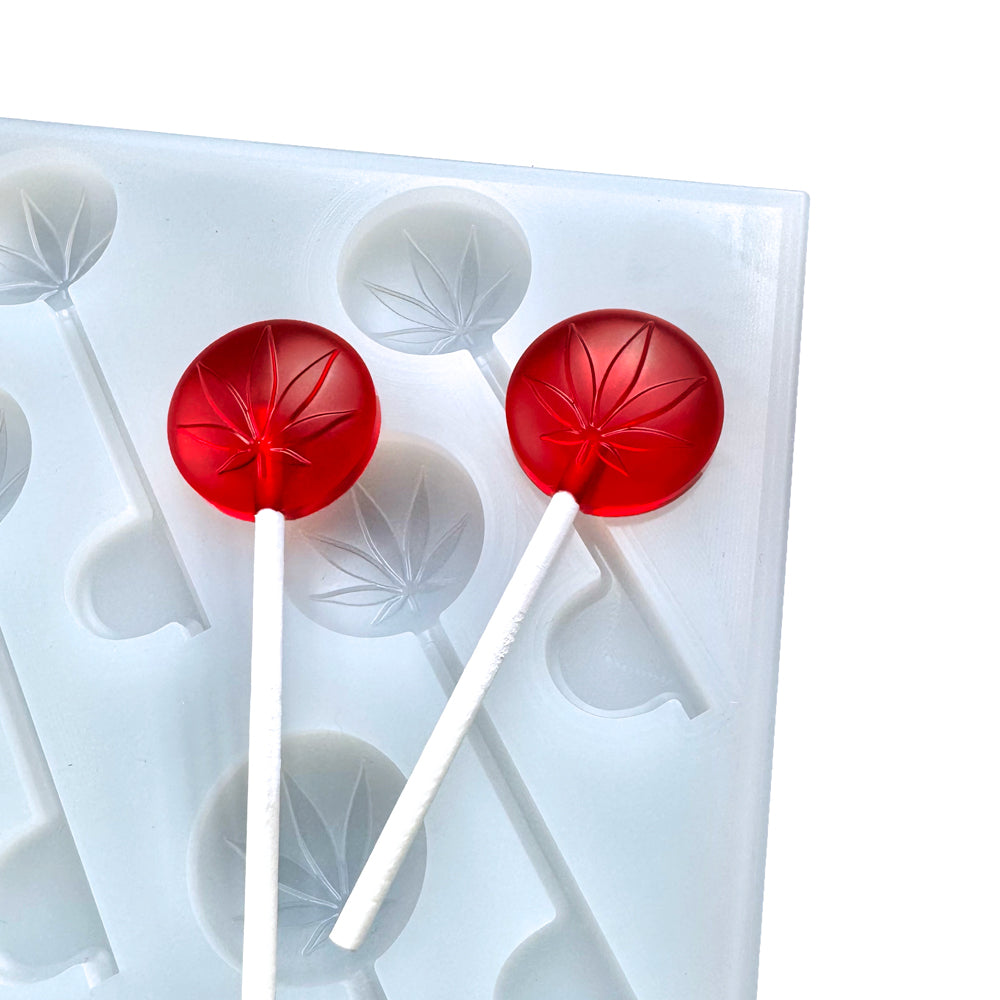 Custom food-grade silicone Sucker mold, 6ml cavities with leaf design, shown with red suckers, compatible with universal depositor machines.